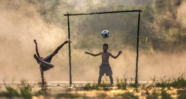 ooscisca objectives, little boy goalkeeping in muddy football field